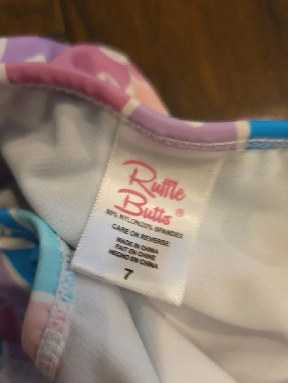 NWOT Ruffle Butts Pastel Pink Purple Aqua One-Shoulder Ruffle Swimsuit Size 7